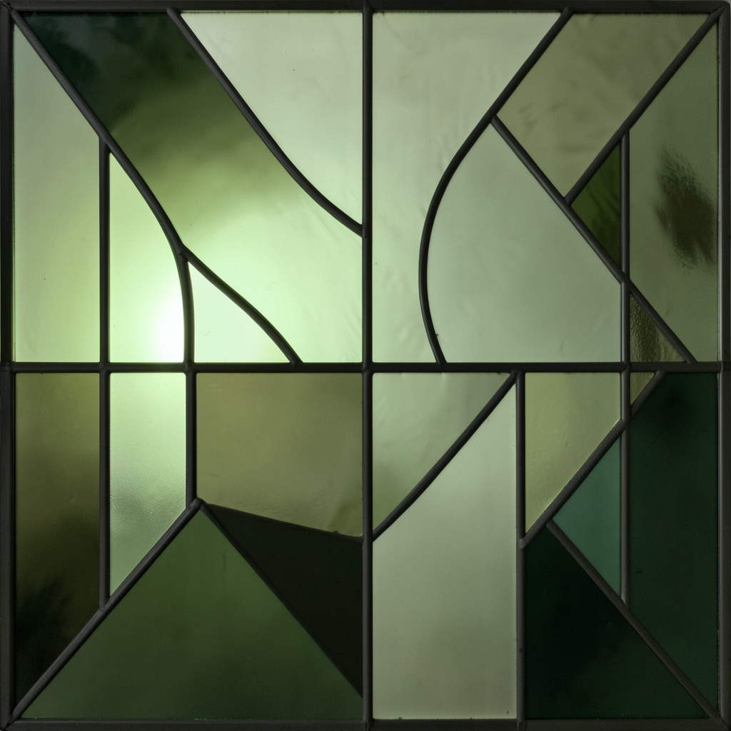 A stained-glass composition with bold leaded segments in muted olive, sage green, and deep forest tones, arranged in an abstract geometric pattern